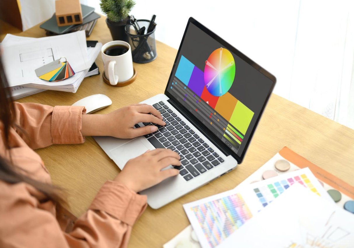 logo designer working laptop